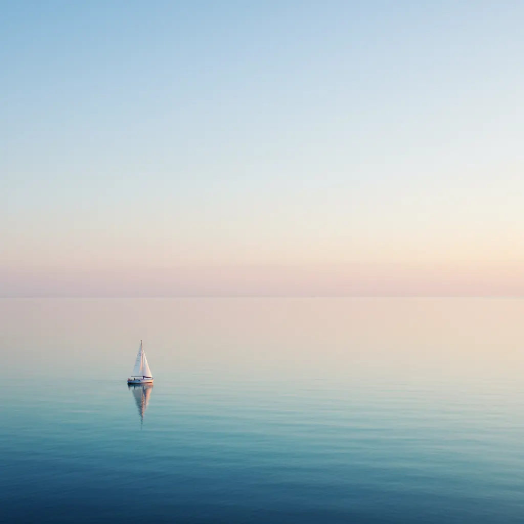 Sailboat on vast ocean demonstrating negative space